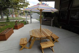 Wooden picnic table with umbrella