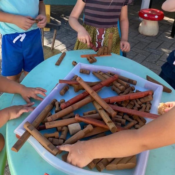 Children playing with wooden blocks on a table
