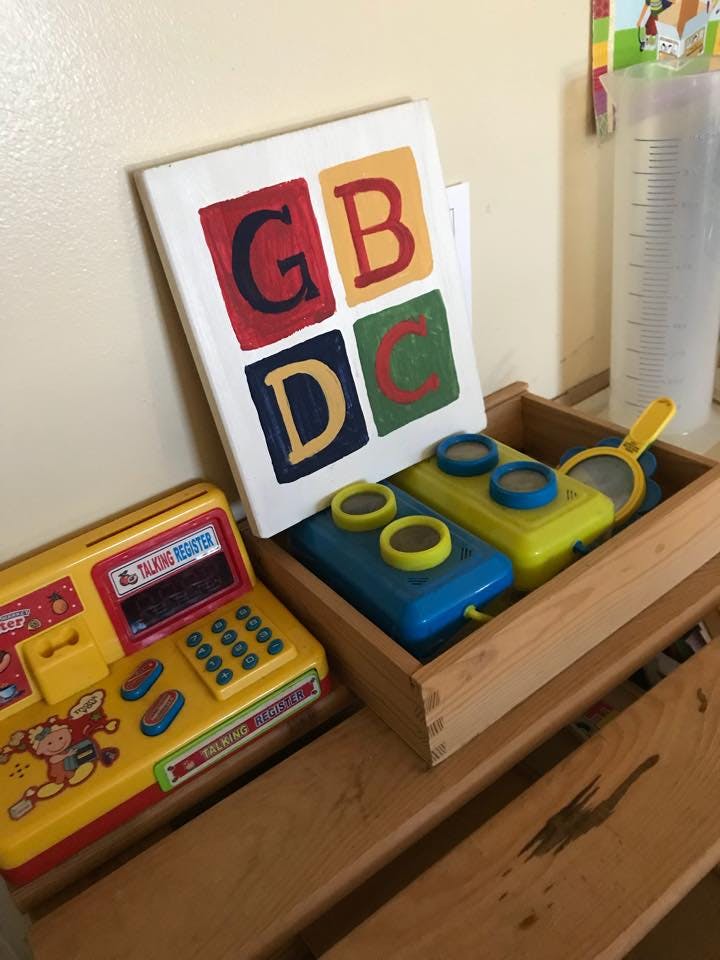 Children's toys including a cash register and alphabet blocks