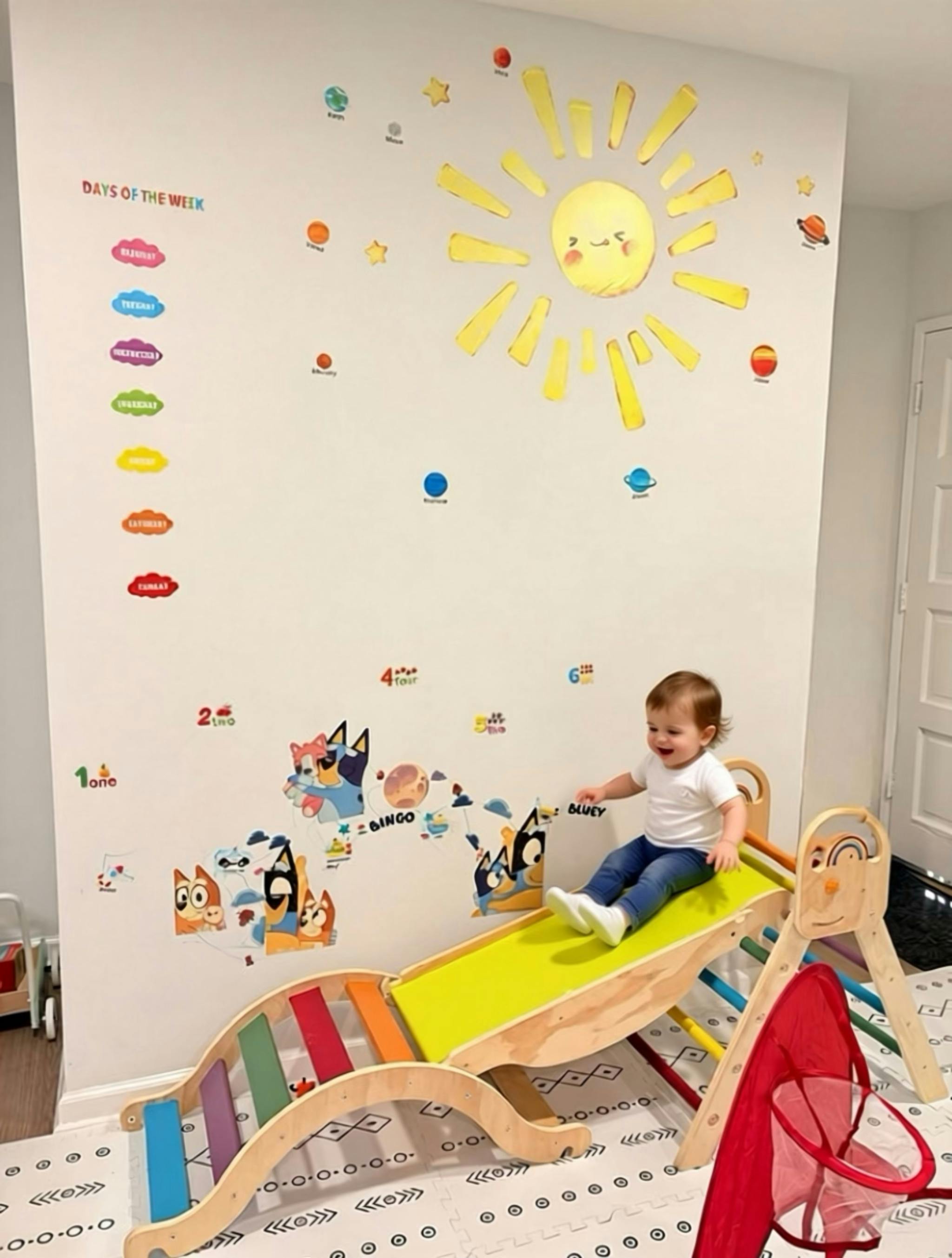Child sliding down a wooden slide with a yellow ramp