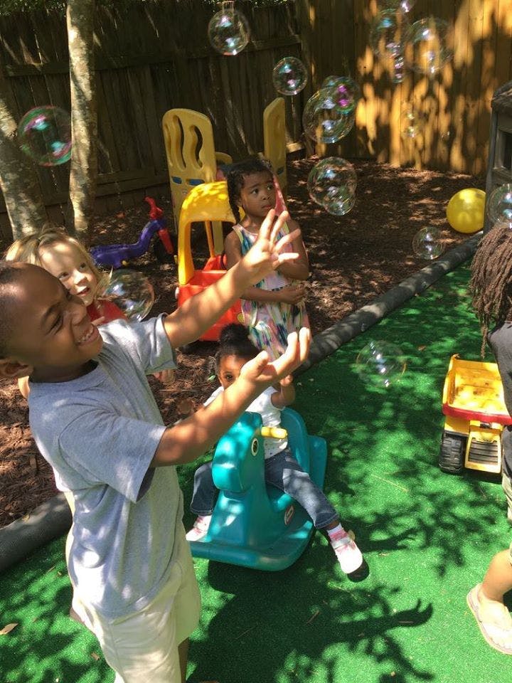 Children playing with bubbles outdoors