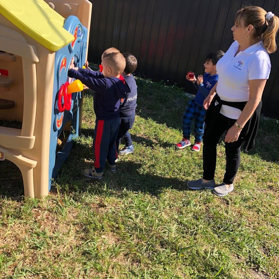 Adult supervising children playing outdoors