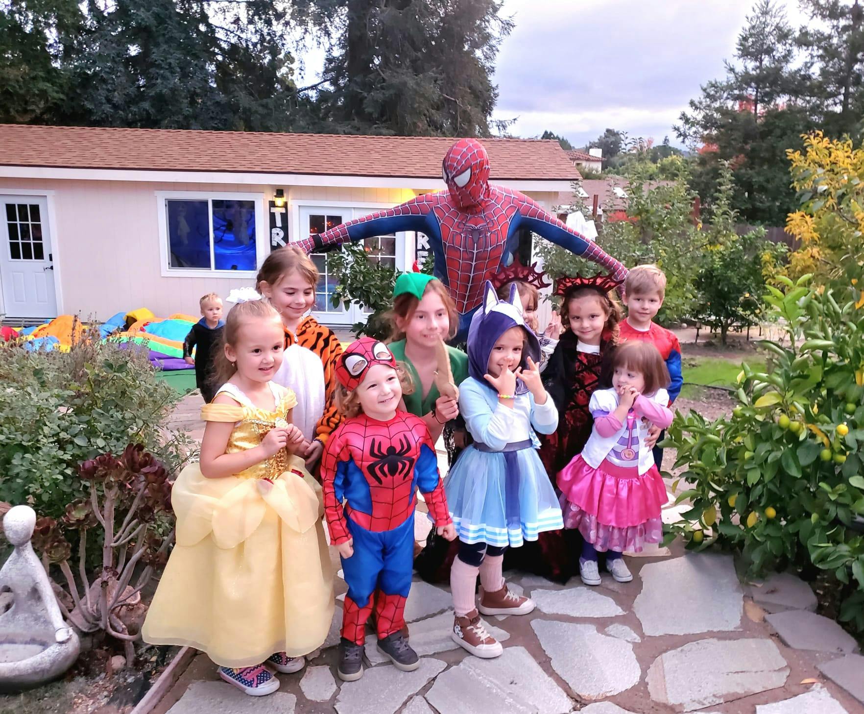 Group of children and a person in a Spiderman costume