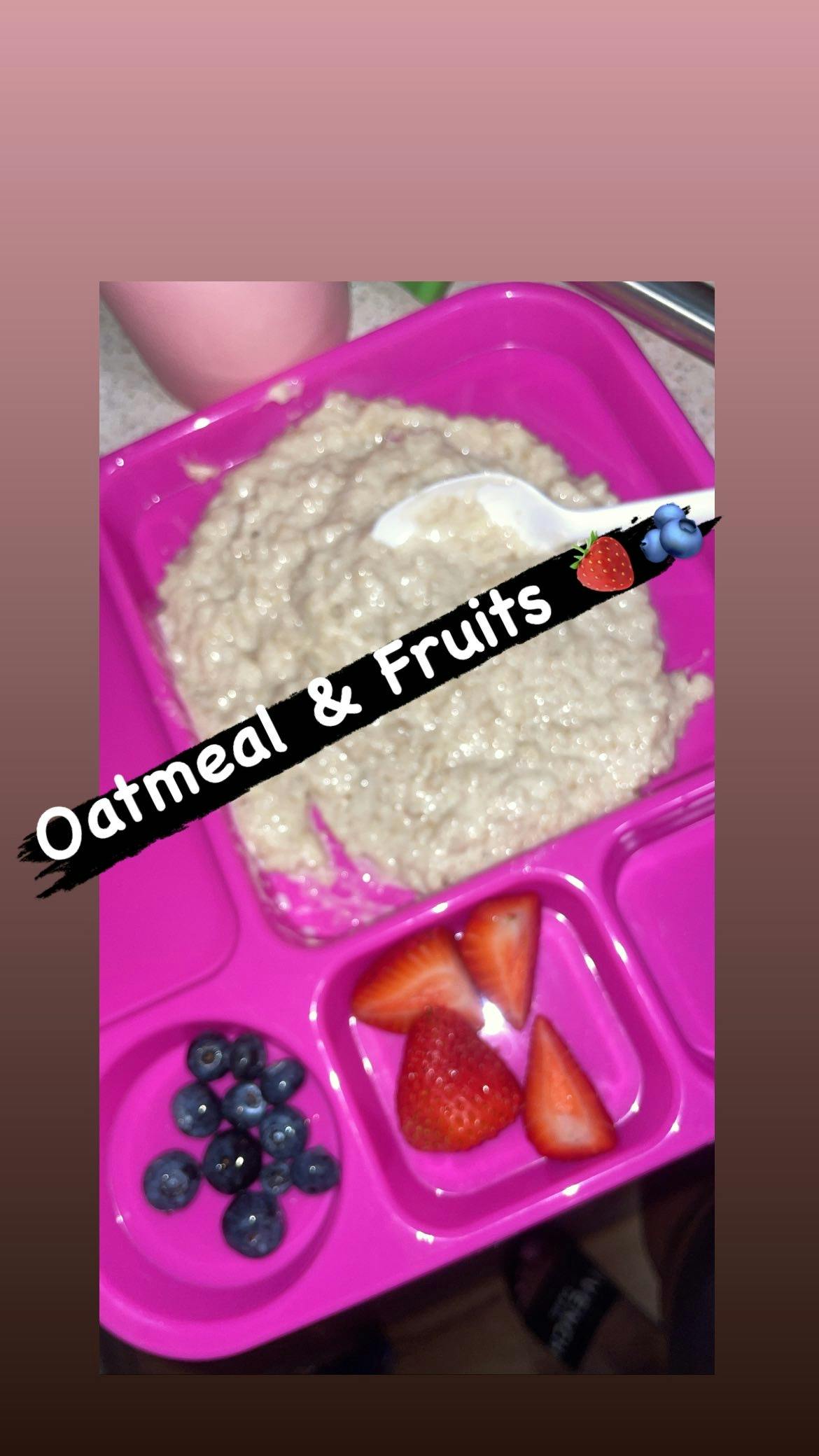 Oatmeal and fruits in a pink divided tray