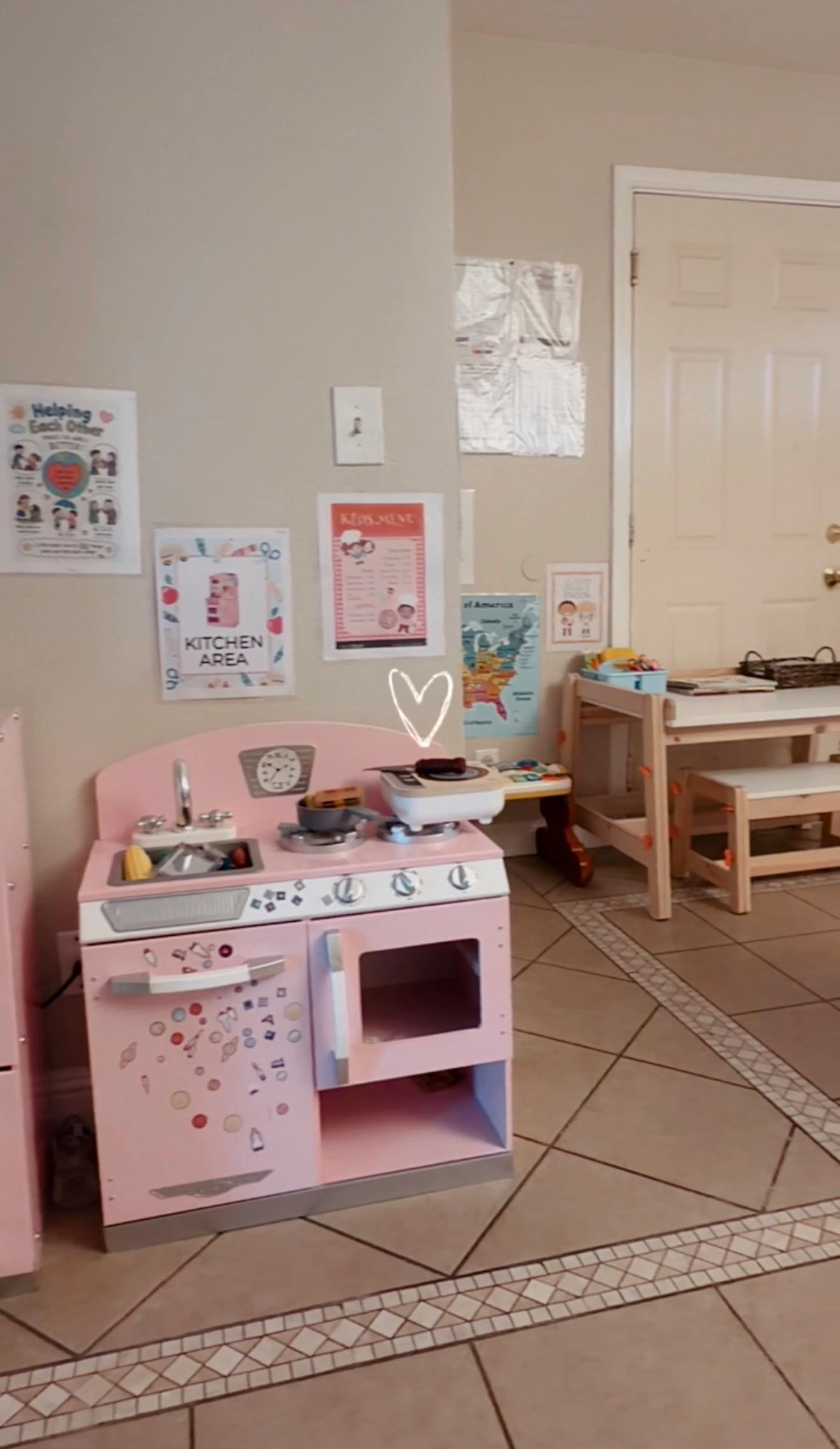 Play kitchen in a room with educational wall posters