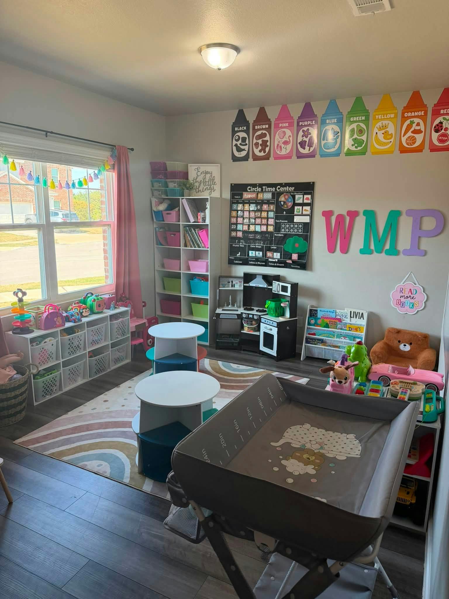 Playroom with children's toys, educational wall posters, and storage shelves