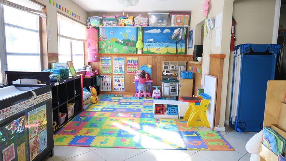 Colorful play area with a patterned mat and various toys