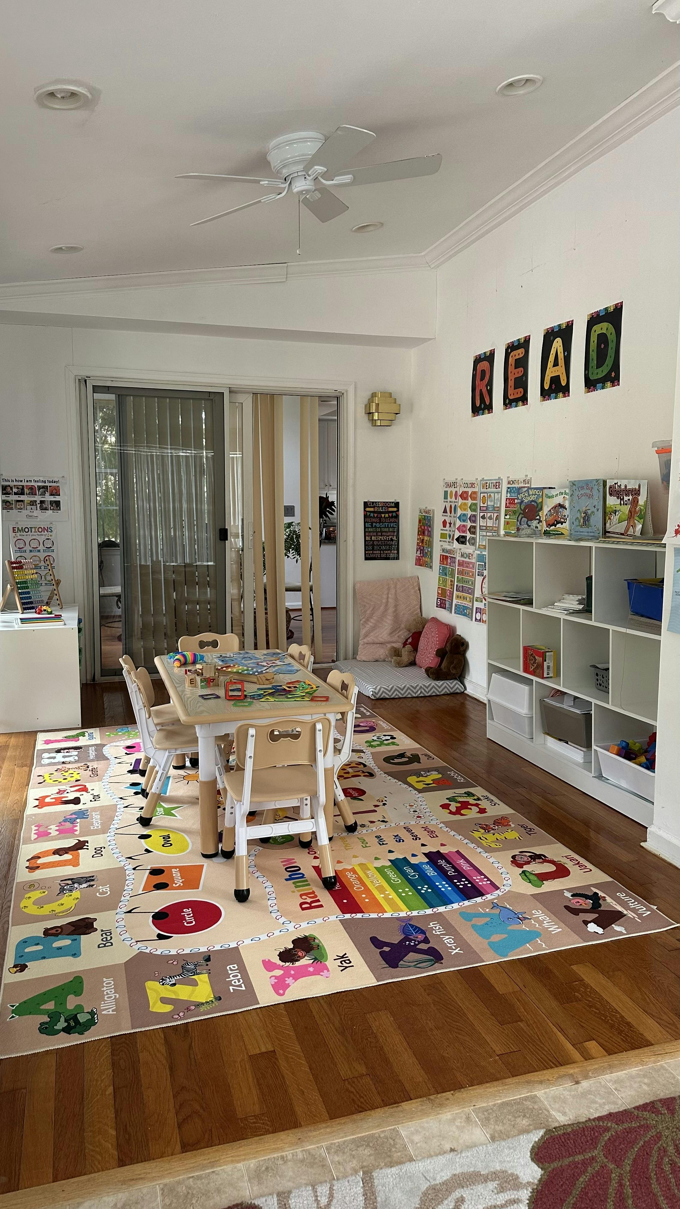 Playroom with a small table and chairs on an alphabet rug