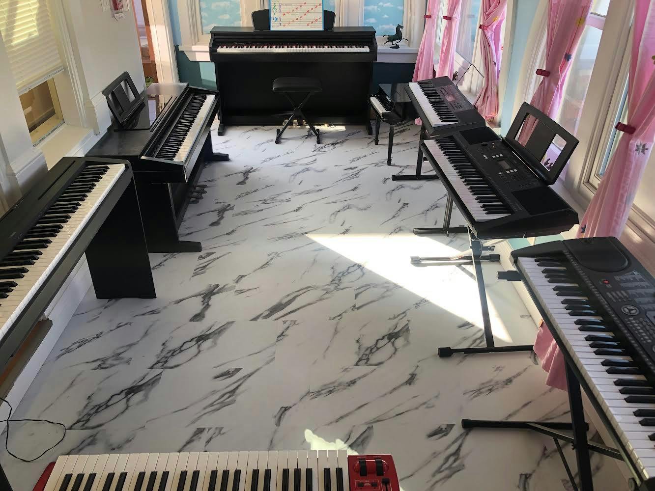 Room with multiple keyboards and digital pianos