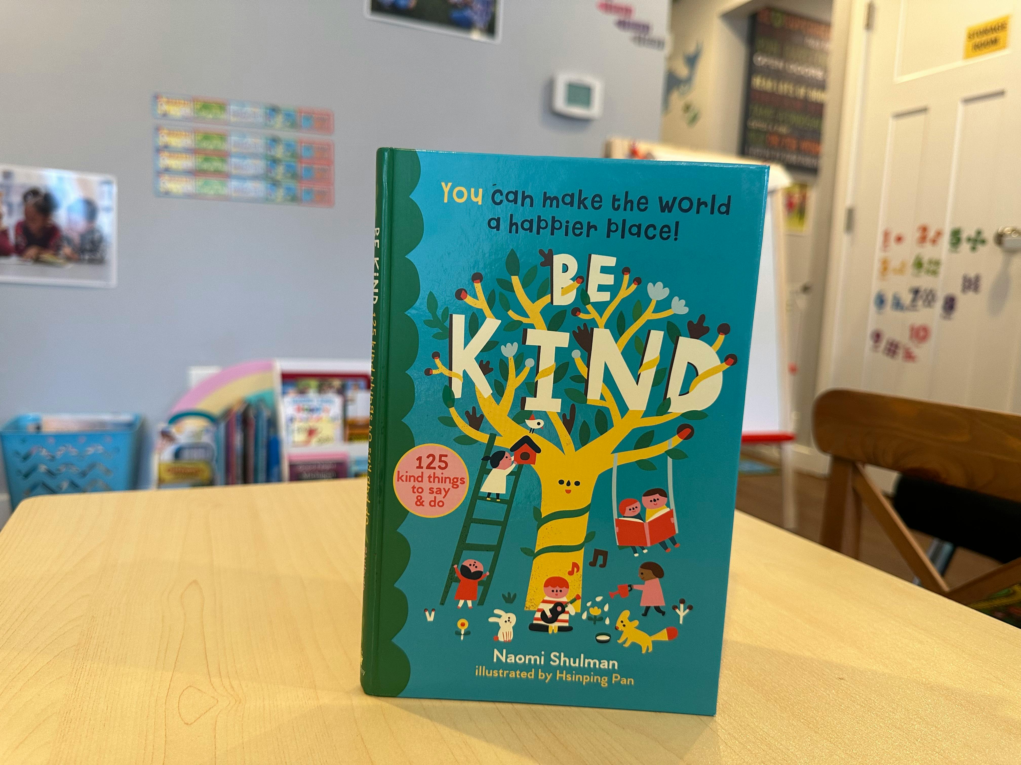 Book titled "Be Kind" on a table in a classroom