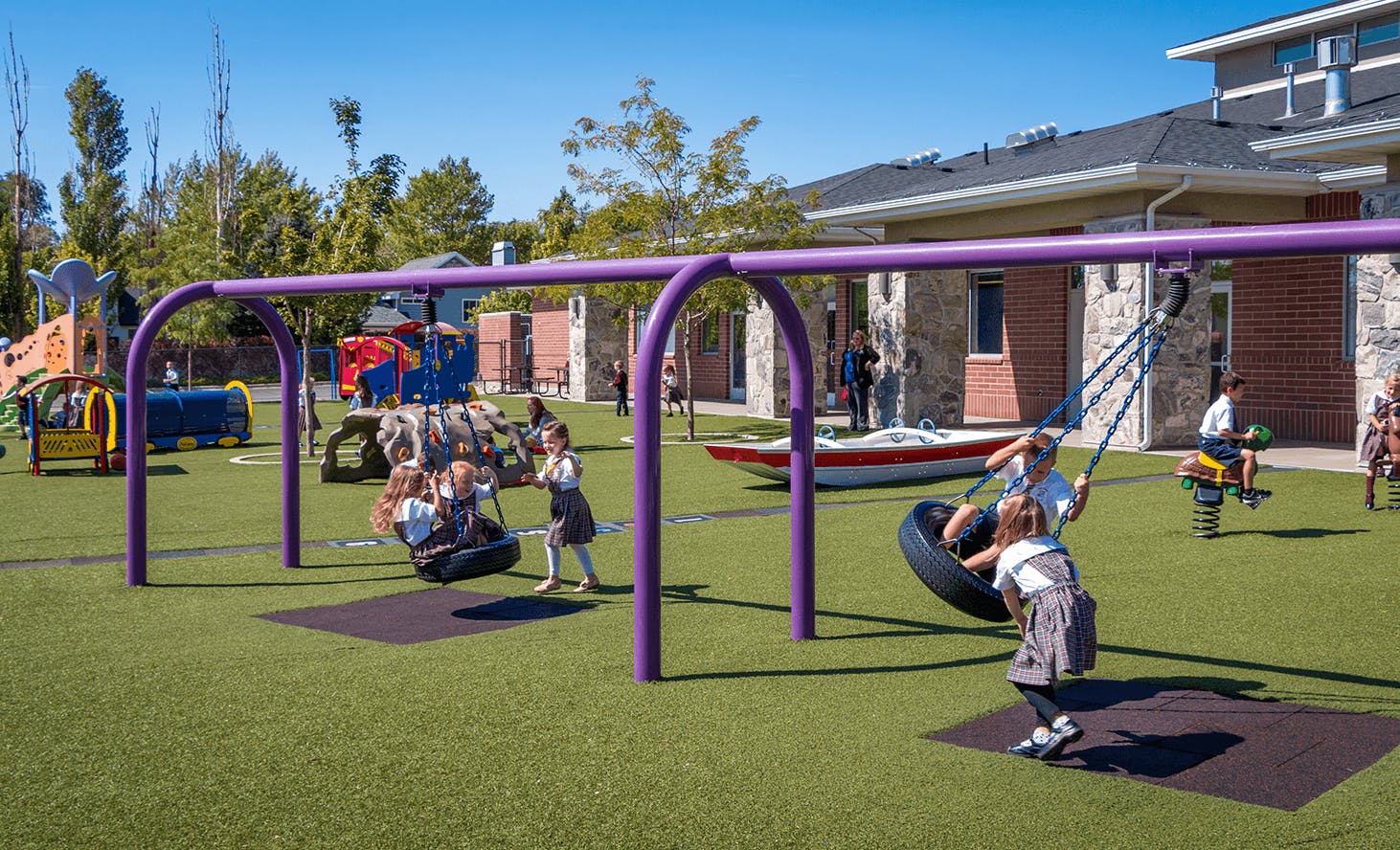 Children playing on swings and playground equipment