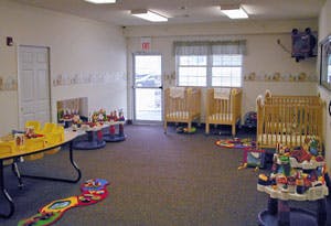 Empty room with cribs and tables with toys