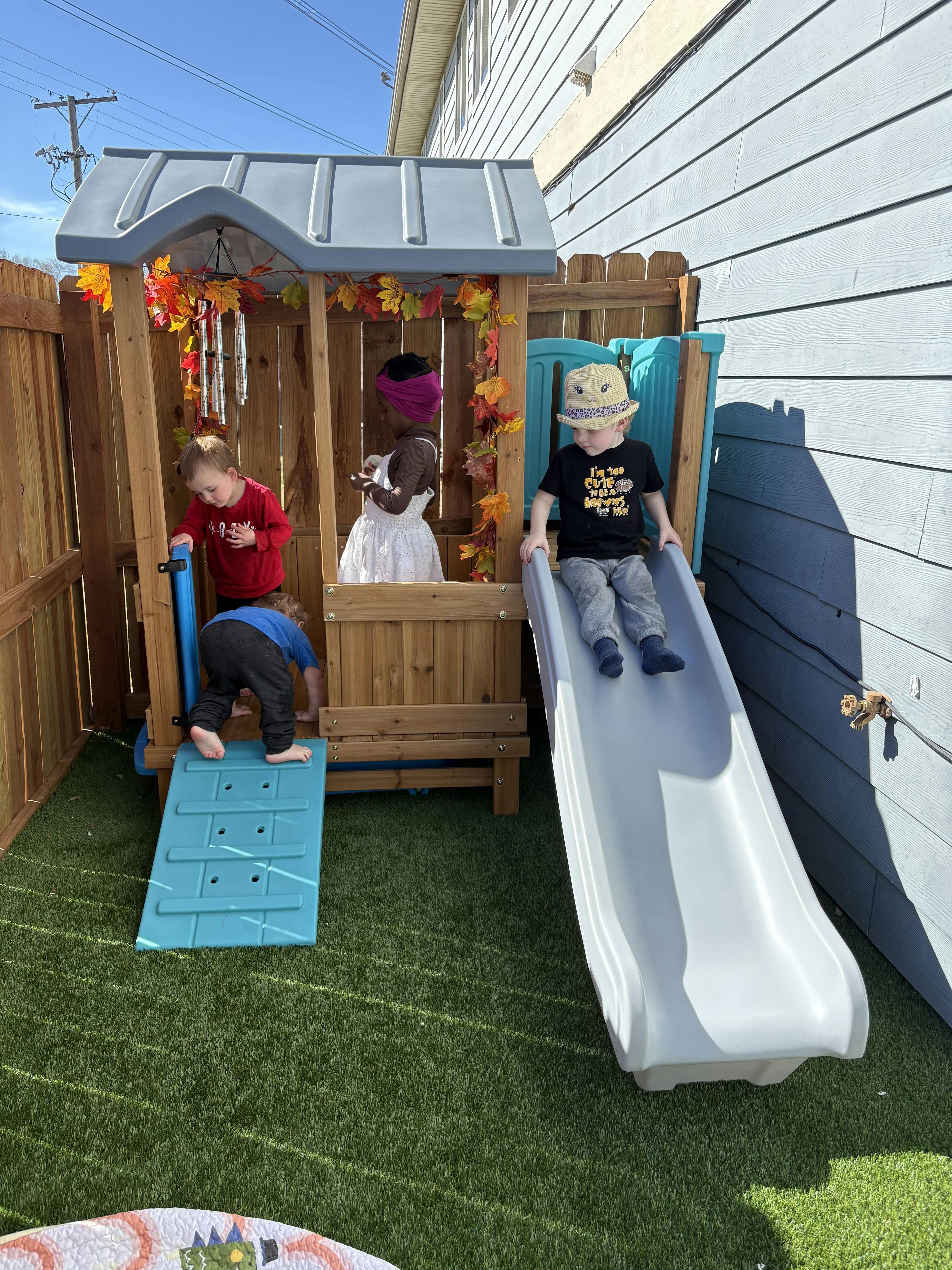 Three children playing on an outdoor playset