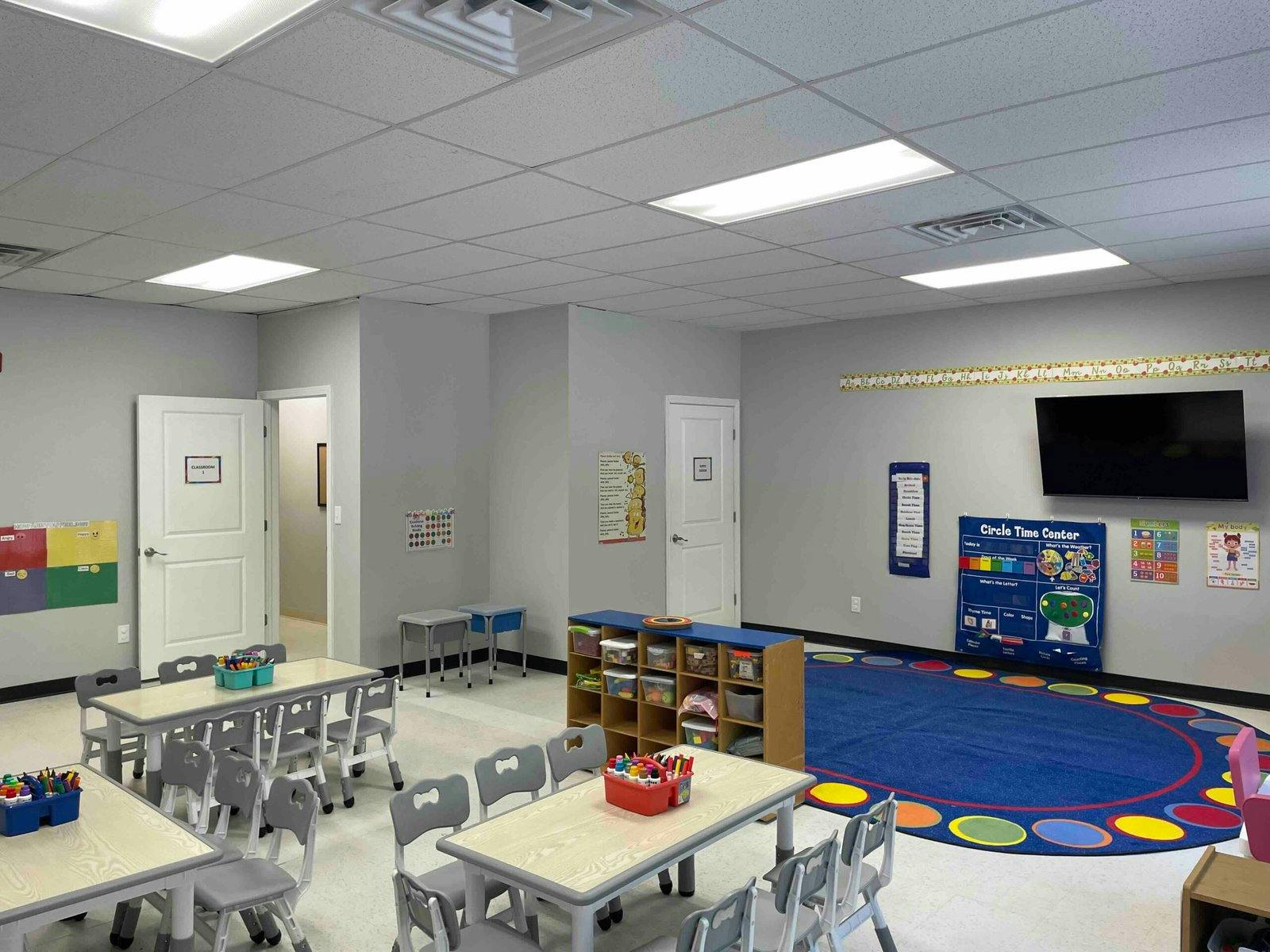 Classroom with small tables, chairs, and learning materials