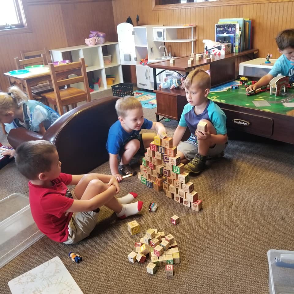 Children playing with building blocks on the floor