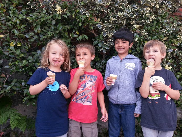 Four children eating ice cream cones