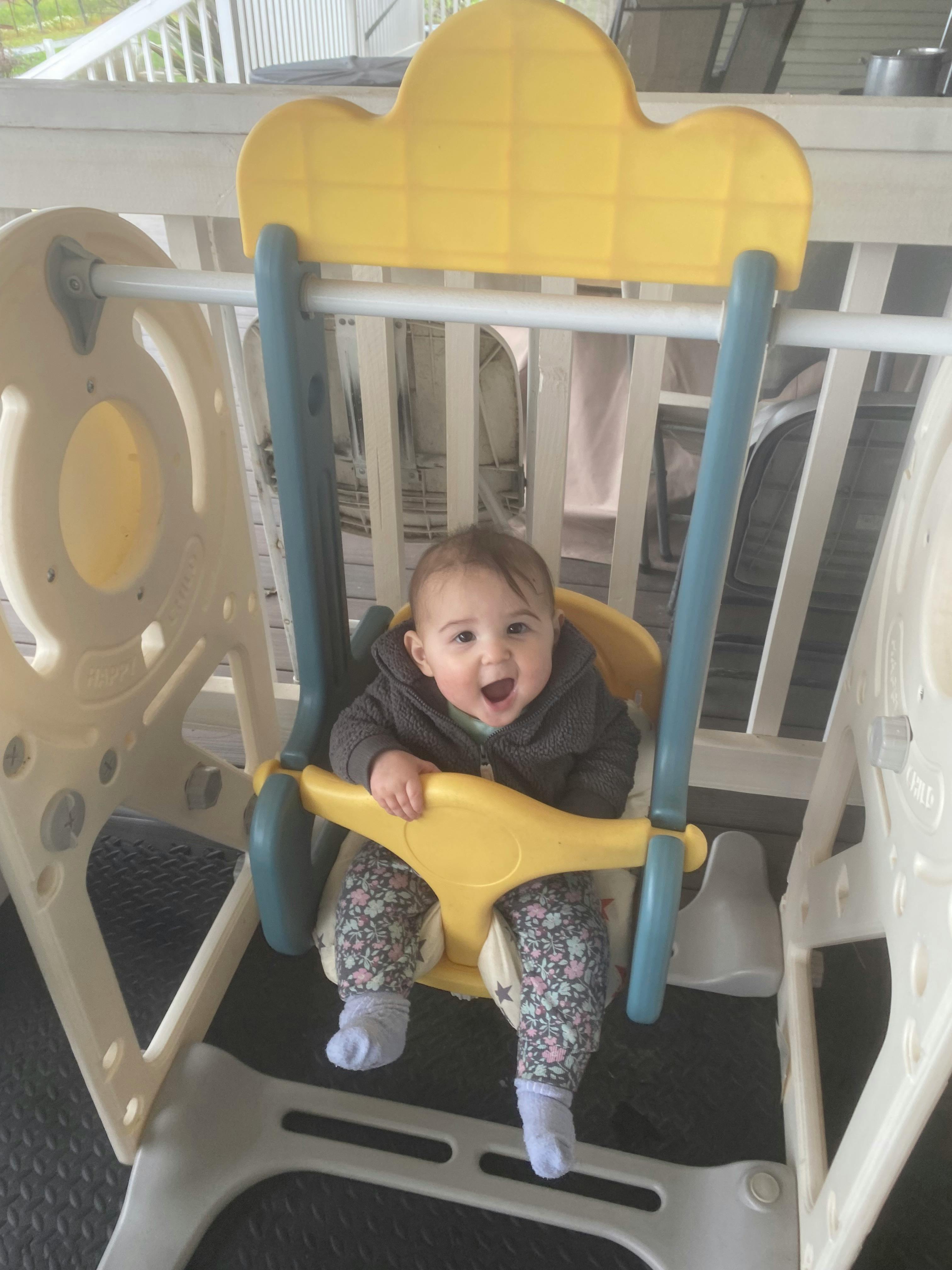 Child in a yellow swing seat