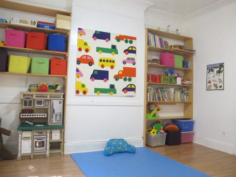 Playroom with toy kitchen, bookshelves, and colorful vehicle art