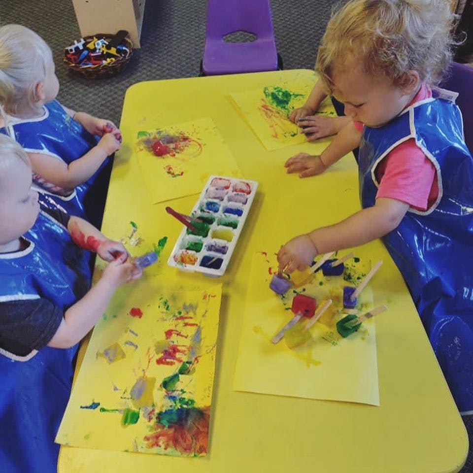 Children painting at a table