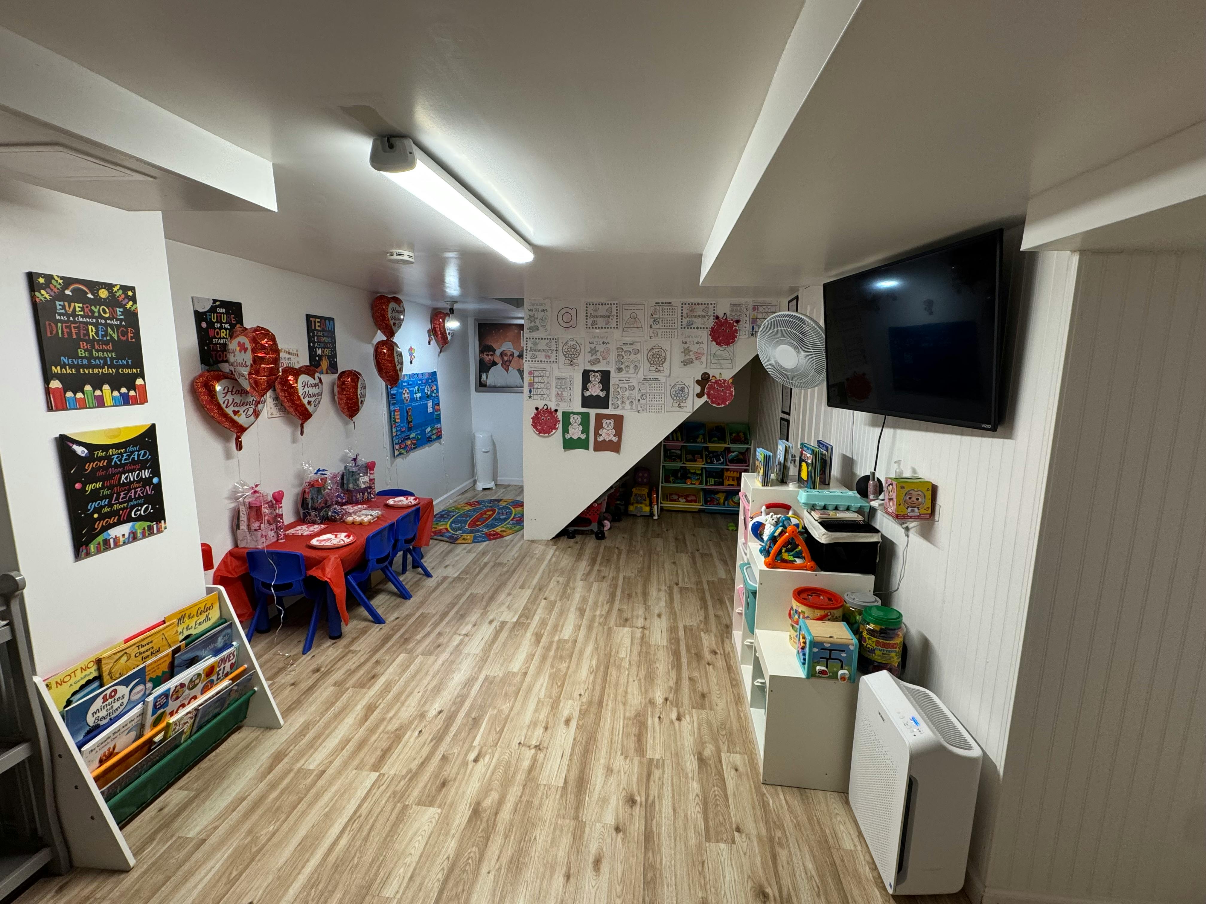 Room decorated with balloons and a table set for a party