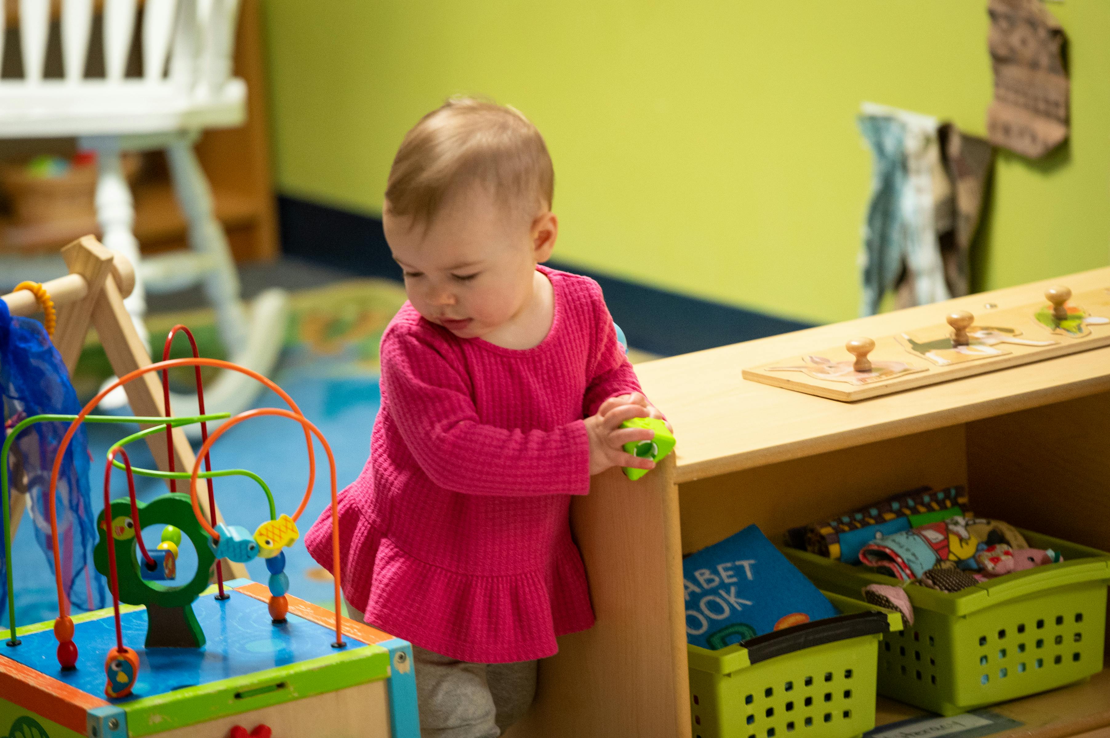 Child playing with a toy in a classroom