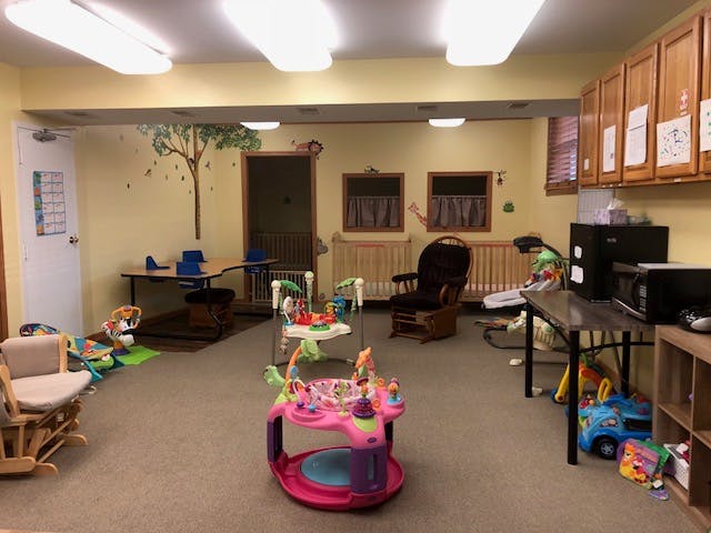 Room with baby play equipment and furniture