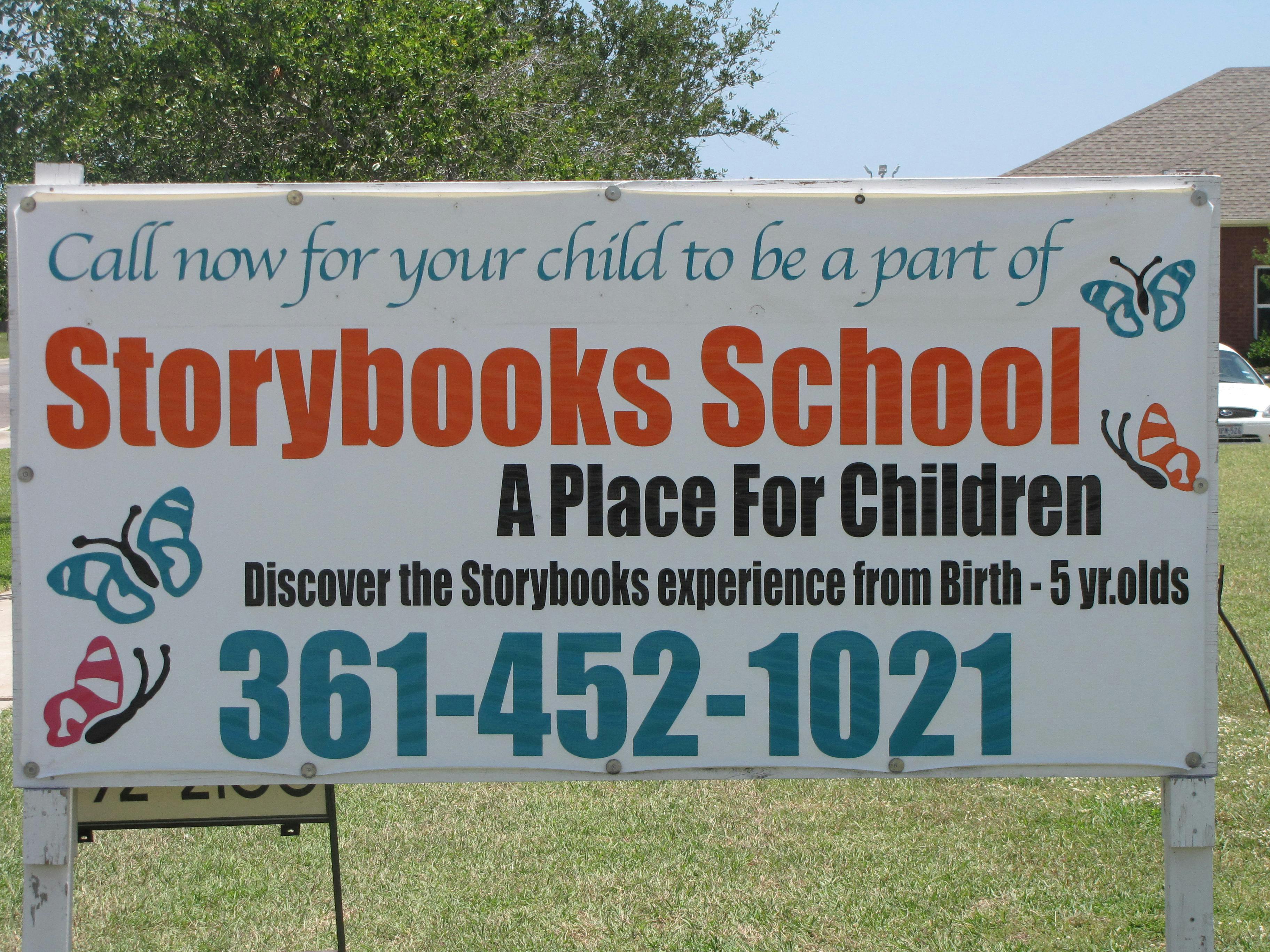 Storybooks School sign with butterflies and phone number