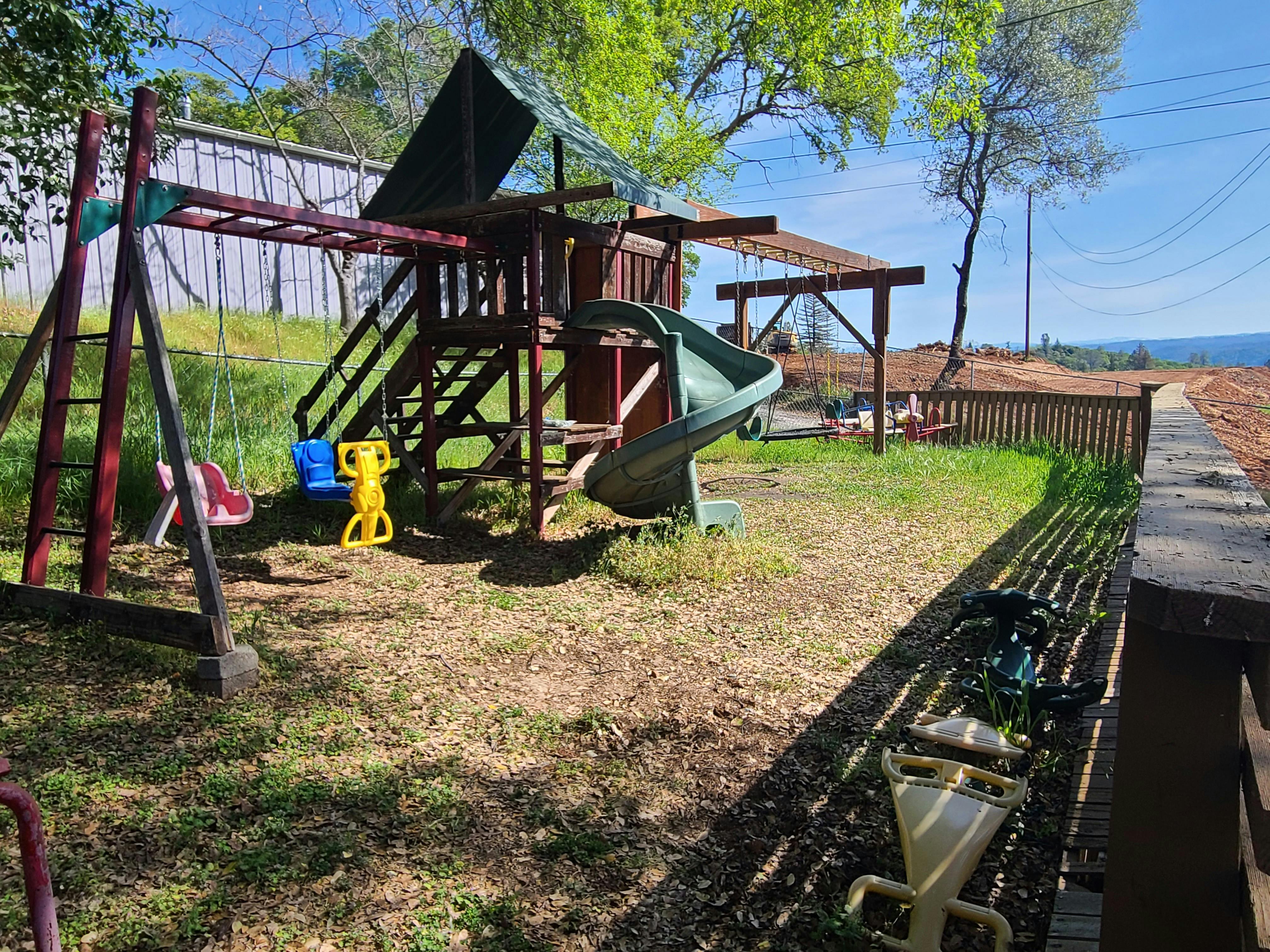 Playground with swings, slide, and climbing structure