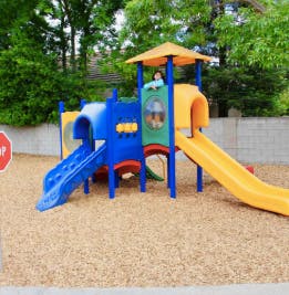 Child on a colorful playground structure with slides