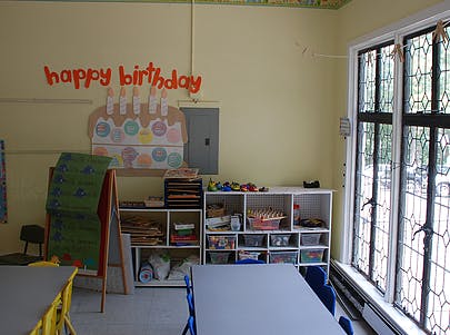 Classroom with "happy birthday" sign and cake decoration on wall
