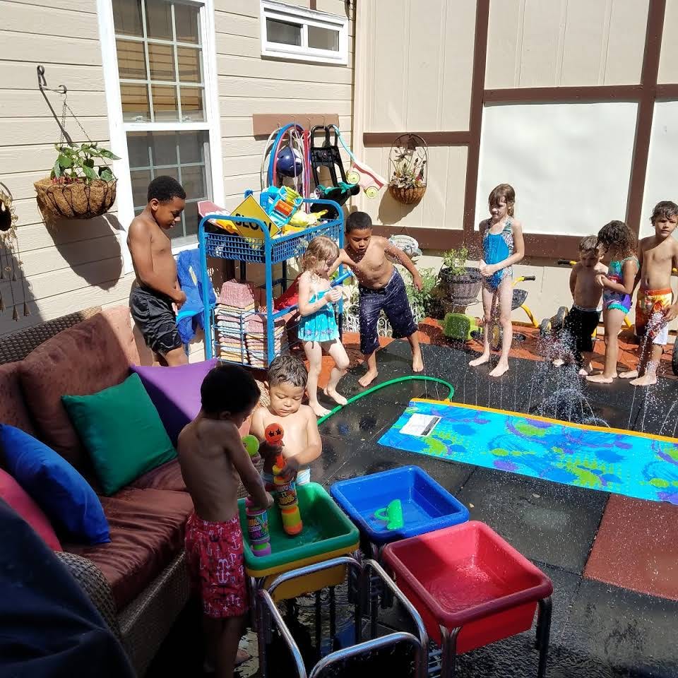 Children playing with water outdoors