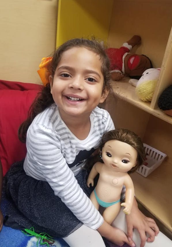 Child holding a doll