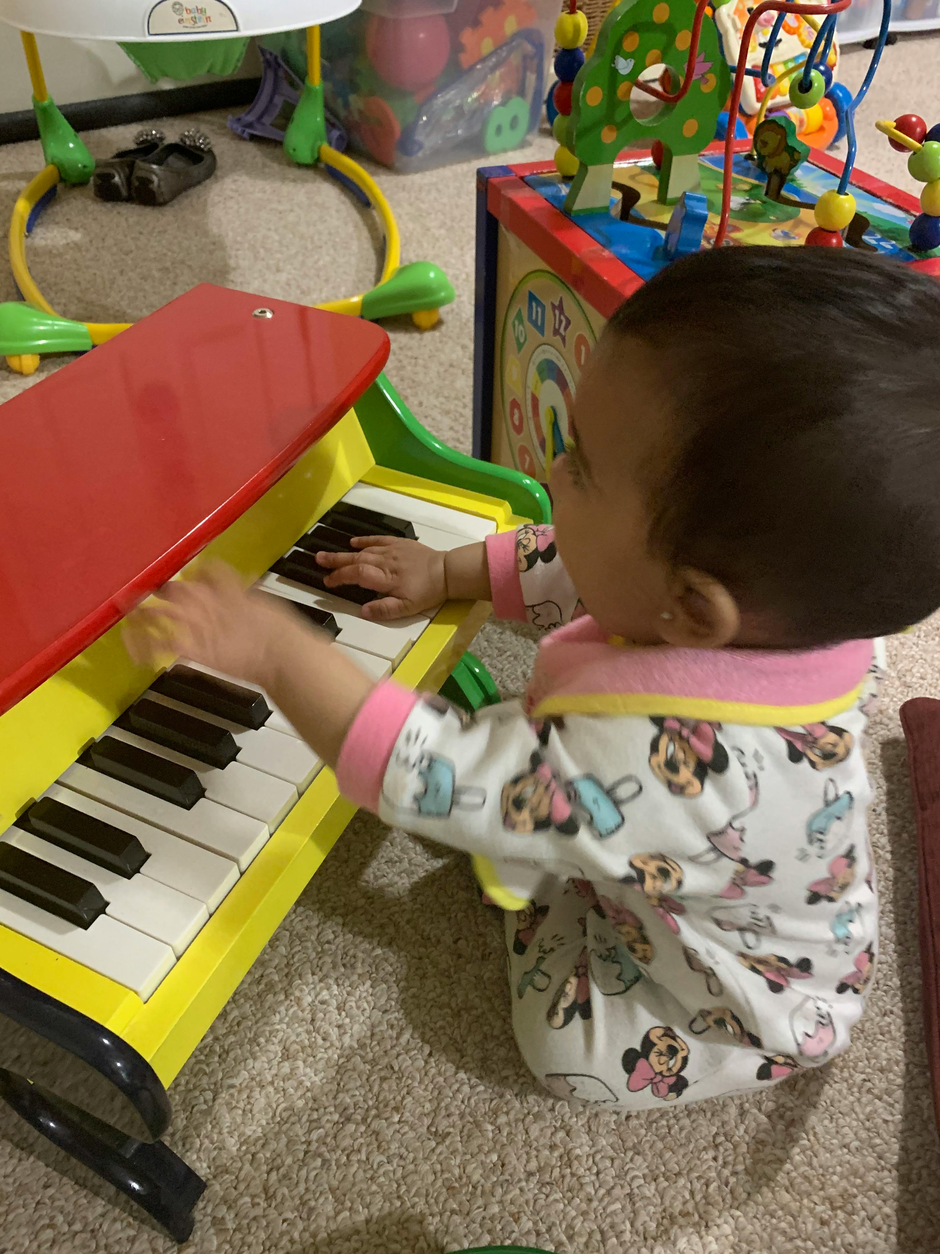Child playing with a toy piano