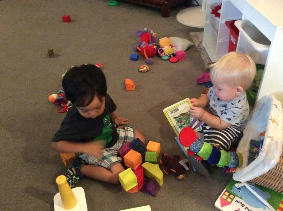 Two children playing with toys on the floor