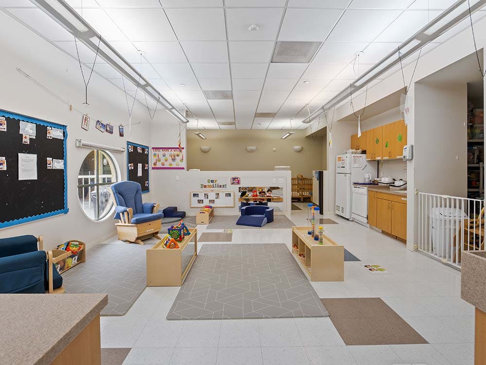 Classroom with child-sized furniture and kitchen area