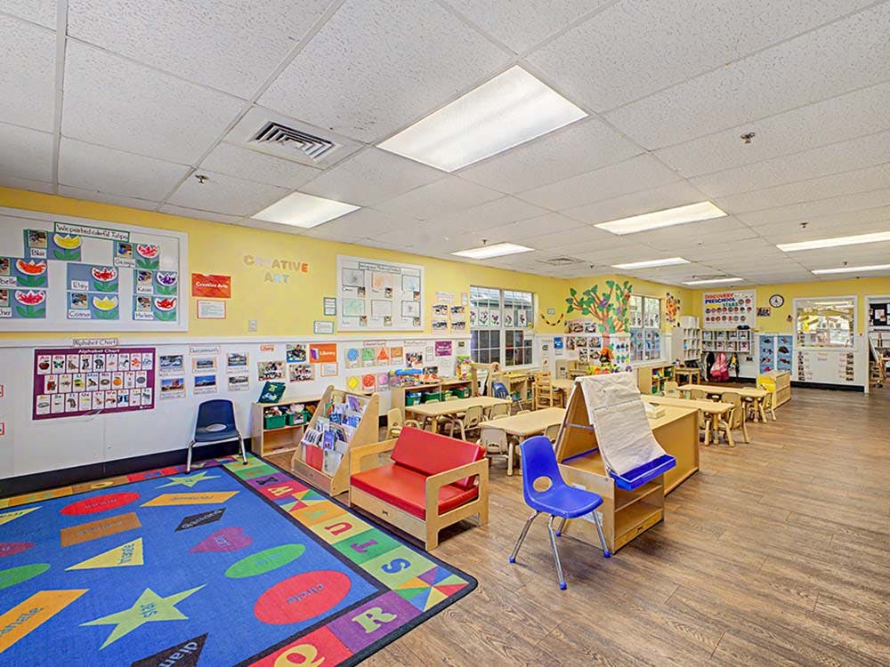 Colorful classroom with small tables, chairs, and learning materials