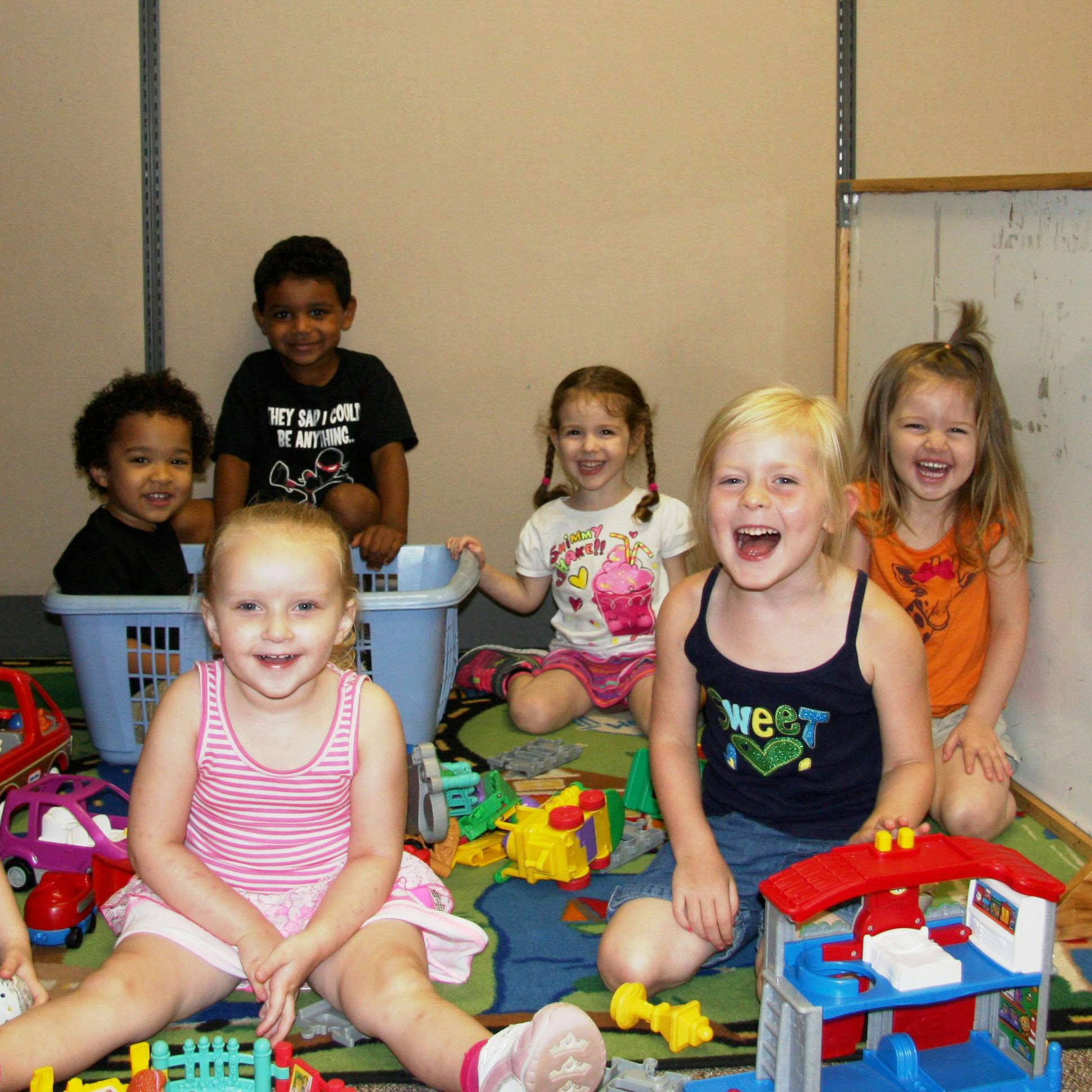 Group of children playing with toys on the floor