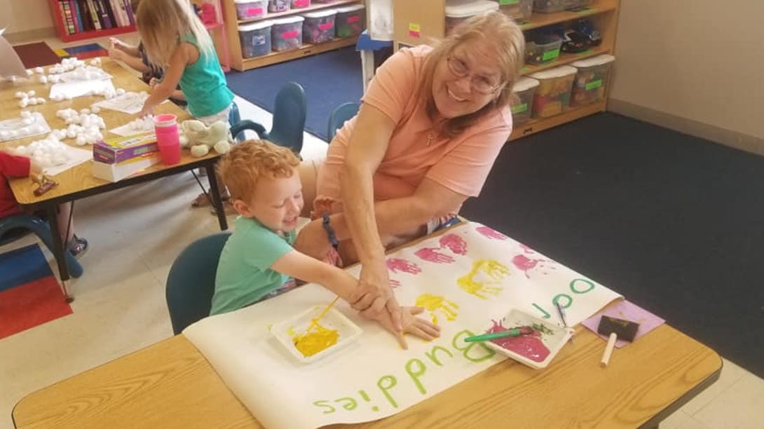 Adult and child doing a craft together at a table