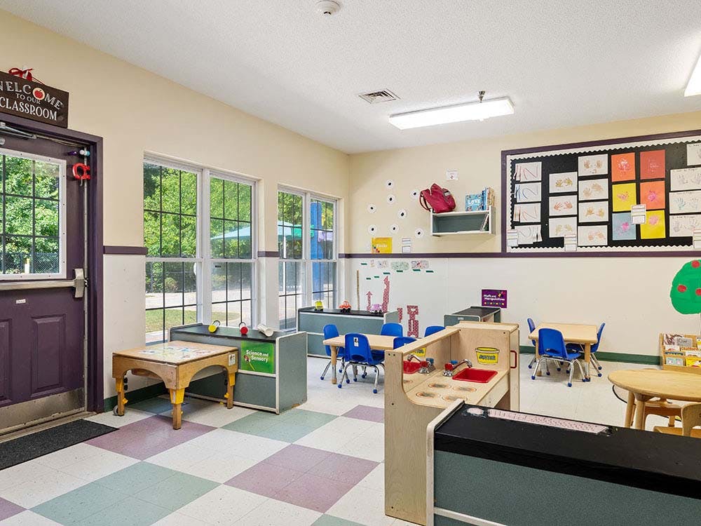 Classroom with small tables, chairs, and learning materials