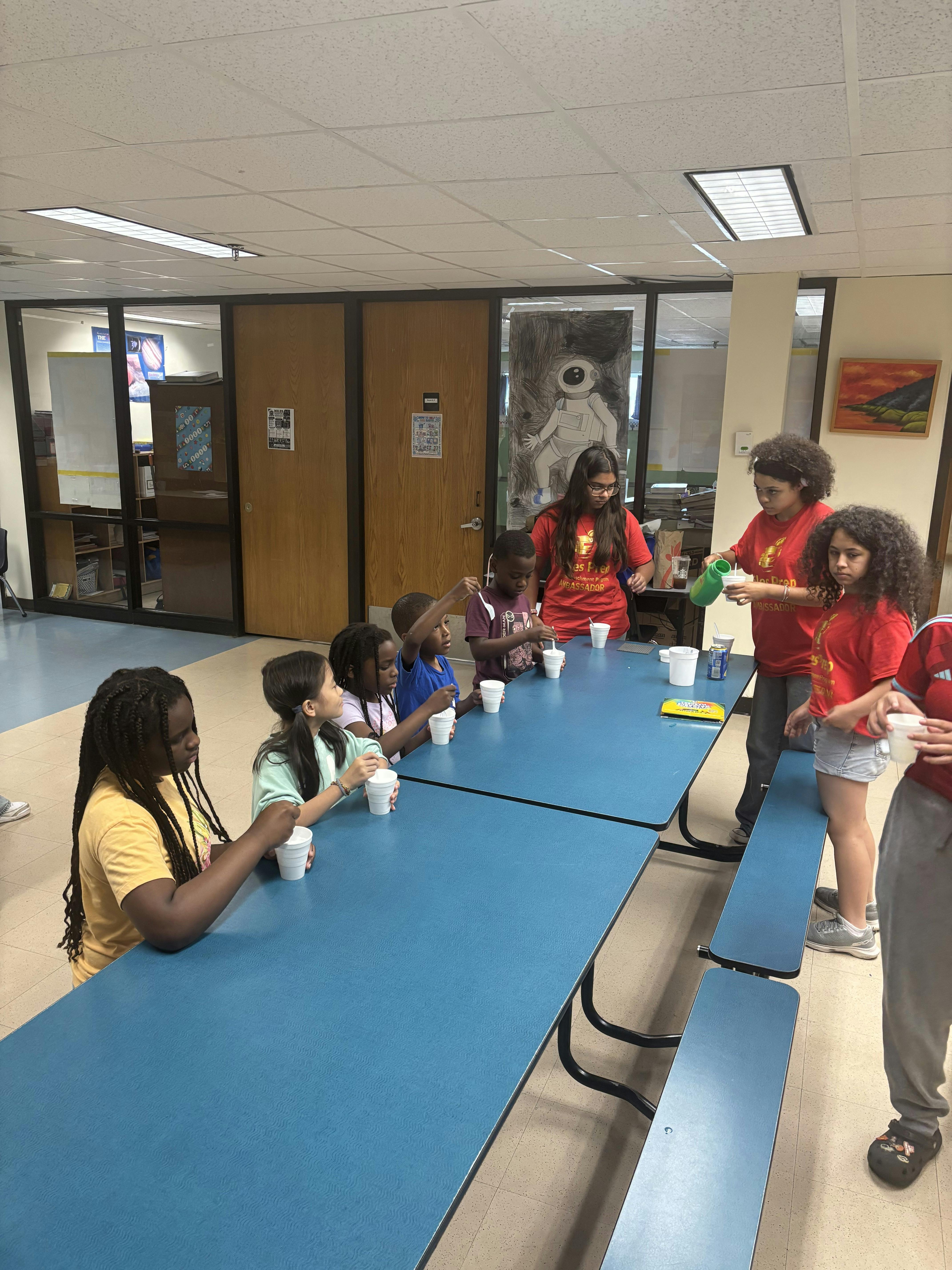 Group of children and teens doing a science experiment at a table