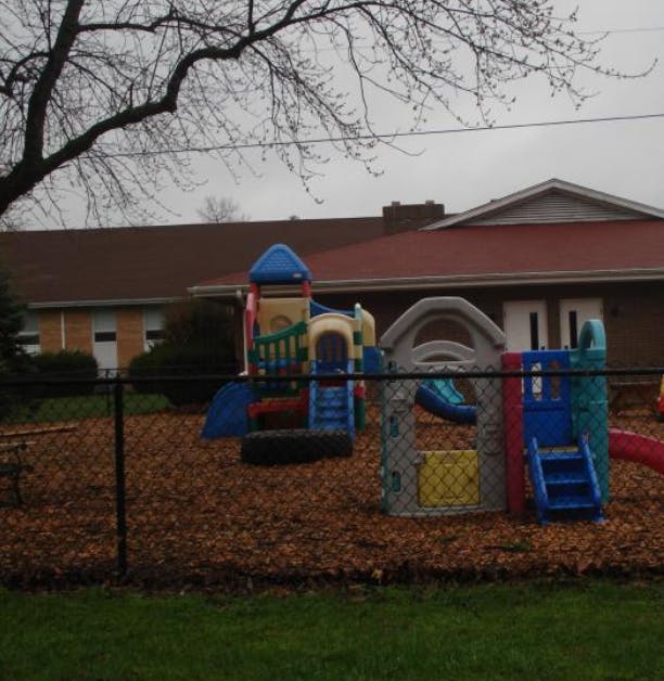 Playground with colorful play structures and wood chips