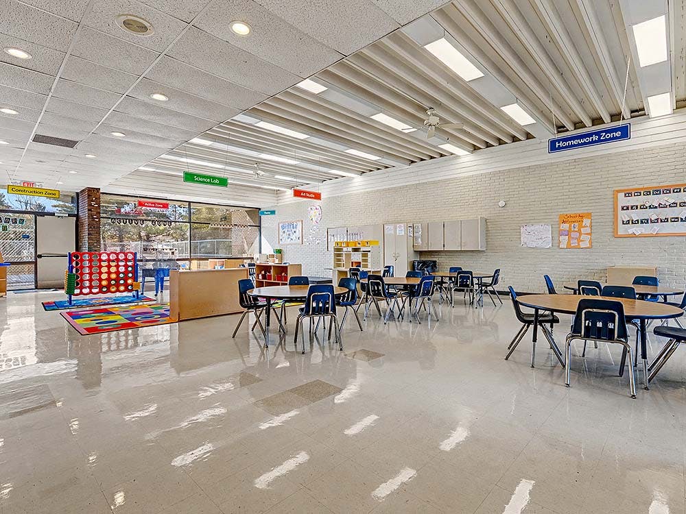 Classroom with tables, chairs, and activity zones