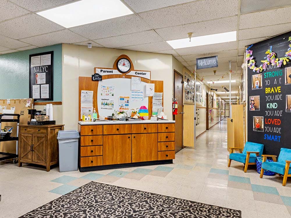 Hallway with a bulletin board labeled "Parent Center" and a wall with photos and text