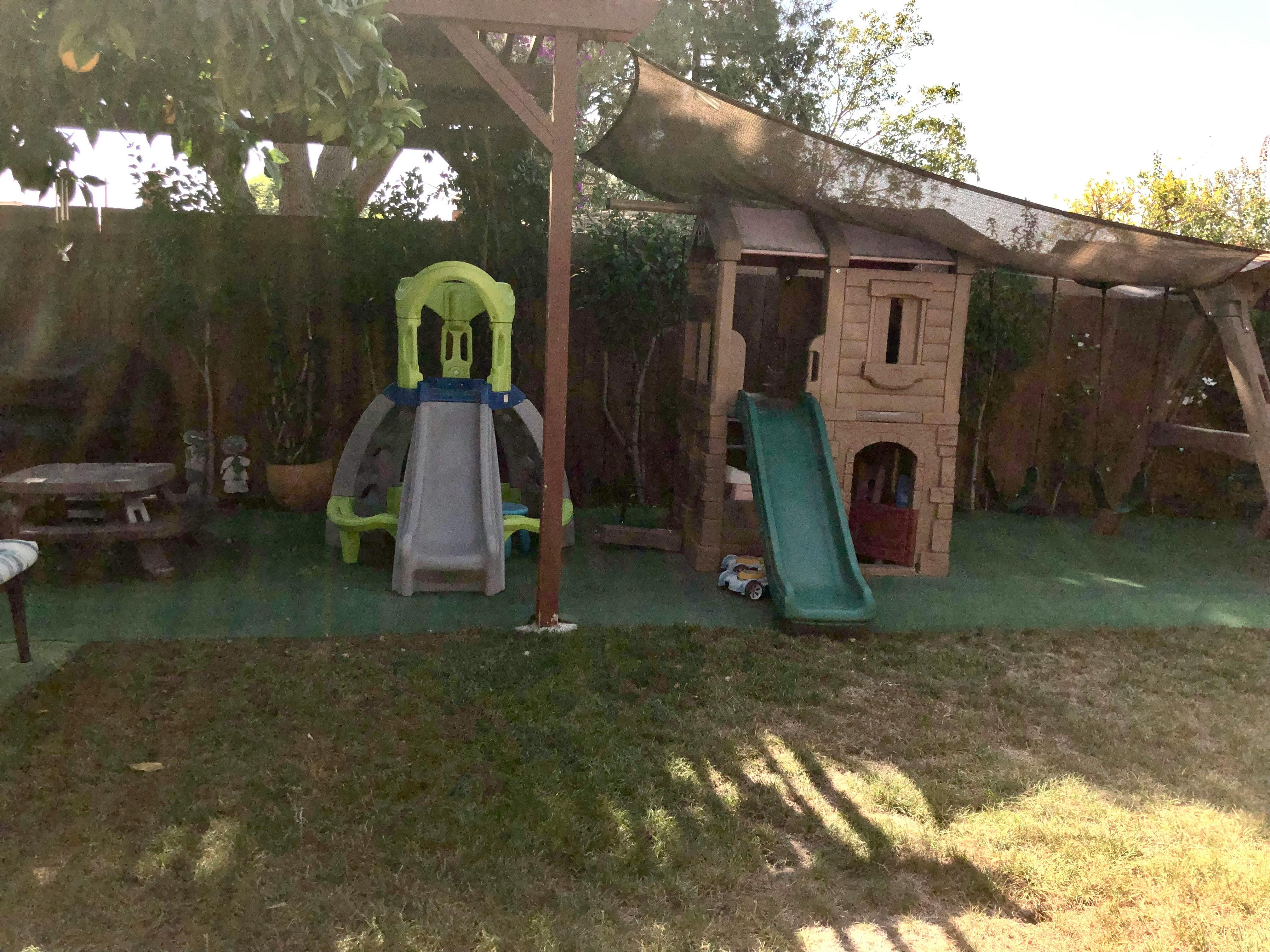 Playground with two slides and a playhouse